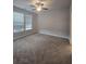 Spacious bedroom featuring two large windows, plush carpet flooring, and a modern ceiling fan at 3405 Ripple Loop # 127, South Fulton, GA 30349