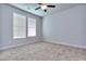 This bedroom features plush carpeting, neutral walls, and ample natural light from two large windows at 3405 Ripple Loop # 127, South Fulton, GA 30349