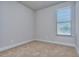 Carpeted bedroom featuring a large window allowing natural light to filter in and illuminate the room at 3405 Ripple Loop # 127, South Fulton, GA 30349