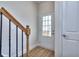 Welcoming entryway with wood-look floors and a glass paneled front door, complemented by an oak handrail and wrought iron balusters at 3405 Ripple Loop # 127, South Fulton, GA 30349