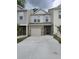 Charming townhome with neutral siding, brick accents, attached garage and newly paved driveway at 3405 Ripple Loop # 127, South Fulton, GA 30349