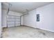 Spacious garage with a concrete floor, an overhead door, and an electrical panel at 3405 Ripple Loop # 127, South Fulton, GA 30349