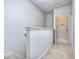 Hallway with neutral carpeting and paint, featuring an open door to a laundry room with essential hookups ready at 3405 Ripple Loop # 127, South Fulton, GA 30349