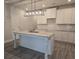 Modern kitchen with white cabinets, granite countertops, an island, and stainless steel sink and faucet at 3405 Ripple Loop # 127, South Fulton, GA 30349