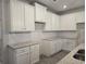 Kitchen showcasing granite countertops, white cabinets, and a stainless steel sink at 3405 Ripple Loop # 127, South Fulton, GA 30349