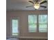 Bright living room with modern ceiling fan, light gray walls, and natural light from two large windows at 3405 Ripple Loop # 127, South Fulton, GA 30349