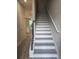 A staircase features wood-look flooring, white risers, and a dark wood handrail at 3405 Ripple Loop # 127, South Fulton, GA 30349