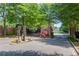A secure, private entrance gate leads into a quiet neighborhood surrounded by mature trees and beautifully maintained landscaping at 2675 Drayton Hall Dr, Buford, GA 30519
