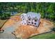 A partially completed two-story home is on a large lot with lake views, surrounded by mature trees at 2675 Drayton Hall Dr, Buford, GA 30519