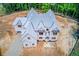 An aerial view shows a new two-story home with gray roof on a large lot in a wooded area at 2675 Drayton Hall Dr, Buford, GA 30519