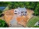 A partially completed two-story home is on a large lot, surrounded by mature trees and landscaping at 2675 Drayton Hall Dr, Buford, GA 30519