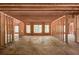 Unfinished great room showing wooden supports and framing with natural light from strategically placed windows at 2675 Drayton Hall Dr, Buford, GA 30519