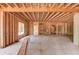 Unfinished basement features wooden beam framing and bare concrete flooring at 2675 Drayton Hall Dr, Buford, GA 30519