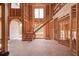 A wooden staircase and large windows accent the unfinished interior of this spacious new home at 2675 Drayton Hall Dr, Buford, GA 30519