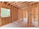 Unfinished interior with exposed wood framing, revealing room layout and window openings to natural light at 2675 Drayton Hall Dr, Buford, GA 30519