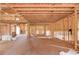 Spacious unfinished interior with exposed framing, wood flooring, and staircase installation underway at 2675 Drayton Hall Dr, Buford, GA 30519