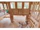 Unfinished interior with exposed wood framing, tall ceilings, and multiple windows at 2675 Drayton Hall Dr, Buford, GA 30519