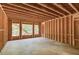 Unfinished living room featuring wooden supports and framing with natural light from strategically placed windows at 2675 Drayton Hall Dr, Buford, GA 30519