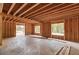 Unfinished living room featuring wooden supports and framing with natural light from strategically placed windows at 2675 Drayton Hall Dr, Buford, GA 30519