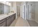 Contemporary bathroom featuring a spacious glass shower, vanity with sink, and tile flooring for a clean look at 550 Whitlox Nw Rd, Atlanta, GA 30318
