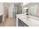 Modern bathroom featuring a glass shower, white countertops, dual vanities, and tiled floors, with recessed lighting at 550 Whitlox Nw Rd, Atlanta, GA 30318