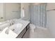 Well-lit bathroom with a single vanity, modern fixtures, a toilet, and a shower with a patterned curtain at 550 Whitlox Nw Rd, Atlanta, GA 30318