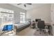 Bedroom featuring a bed, desk, and large windows, creating a functional and well-lit living space at 550 Whitlox Nw Rd, Atlanta, GA 30318