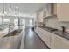 Modern kitchen with stainless steel appliances, white cabinets, and a large center island at 550 Whitlox Nw Rd, Atlanta, GA 30318