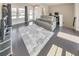 Open living room with a large rug, gray sofa, hardwood floors, and plenty of sunlight at 550 Whitlox Nw Rd, Atlanta, GA 30318