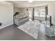 Cozy living room with gray sofa, TV, large windows, hardwood floors, and modern decor at 550 Whitlox Nw Rd, Atlanta, GA 30318