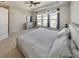 Bright main bedroom featuring a large window, ceiling fan, and dresser, providing ample natural light and storage at 550 Whitlox Nw Rd, Atlanta, GA 30318