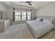 Spacious bedroom with tray ceilings, large windows, and a ceiling fan, offering a bright and airy feel at 550 Whitlox Nw Rd, Atlanta, GA 30318