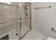 Bathroom stall shower featuring white tiled walls, a showerhead, and glass doors at 550 Whitlox Nw Rd, Atlanta, GA 30318