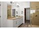 Bathroom featuring a dual sink vanity with granite countertops, glass shower and a walk-in closet at 330 Wagon Way, Alpharetta, GA 30009