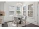 Bright dining area with large windows, plantation shutters, and a modern light fixture, great for Gathering meals at 330 Wagon Way, Alpharetta, GA 30009