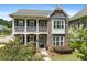 Brick two-story home with front porch and landscaped yard at 330 Wagon Way, Alpharetta, GA 30009