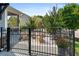 Cozy front yard featuring a black metal fence, mature landscaping, and outdoor seating at 330 Wagon Way, Alpharetta, GA 30009