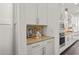 Well-lit kitchen featuring sleek cabinetry, stainless steel appliances, and a tiled backsplash for a modern aesthetic at 330 Wagon Way, Alpharetta, GA 30009