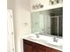 Bathroom featuring double sink vanity and a glass enclosed shower at 389 Meeting St, Mcdonough, GA 30252