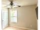 Bedroom featuring neutral walls, carpet floors, ceiling fan, and a bright window at 389 Meeting St, Mcdonough, GA 30252