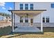 Covered patio with ceiling fan, adjacent to grassy backyard at 6300 Misty Hill Ln, Buford, GA 30518