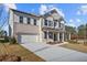 Two-story home with brick exterior, attached garage, and front porch at 6300 Misty Hill Ln, Buford, GA 30518