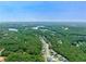 Aerial view of houses nestled in a wooded area with a lake at 366 Boundless Ln, Canton, GA 30114