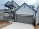 Two-story house with gray siding, stone accents, and a two-car garage at 366 Boundless Ln, Canton, GA 30114