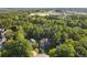 Aerial view of house nestled in wooded area with a long driveway at 503 W Green Ct, Woodstock, GA 30189