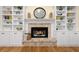 Brick fireplace flanked by white built-in shelving units at 503 W Green Ct, Woodstock, GA 30189