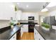 Modern kitchen with white cabinets, granite counters, and island at 503 W Green Ct, Woodstock, GA 30189