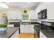 Modern kitchen with white cabinets, granite counters, and island at 503 W Green Ct, Woodstock, GA 30189