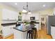 Modern kitchen with white cabinets, granite counters, and island at 503 W Green Ct, Woodstock, GA 30189