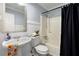 Cozy bathroom featuring a black shower curtain, a sink, and a toilet at 626 Dover St, Marietta, GA 30066